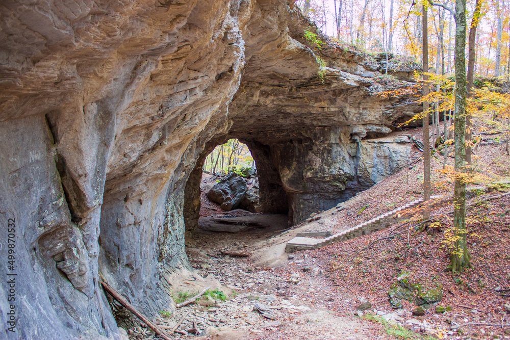 Weathered stone arch cave in the forest