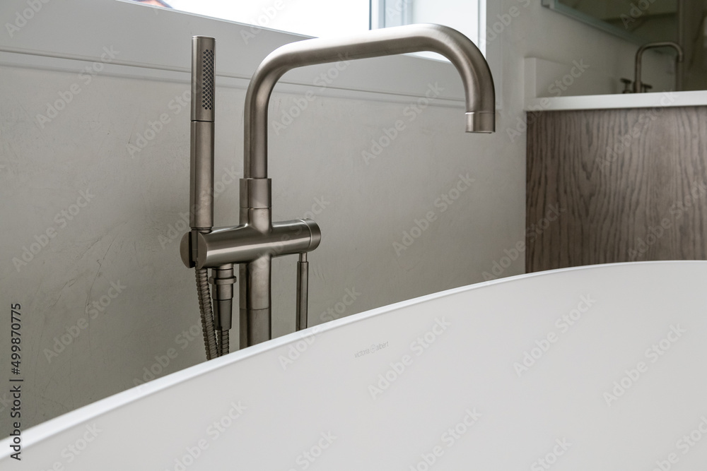 High End Faucet Free Standing Tub. Close up of matte steel faucet for free standing soaking tub. High End Faucet Free Standing Tub. Close up of matte steel faucet for free standing soaking tub.