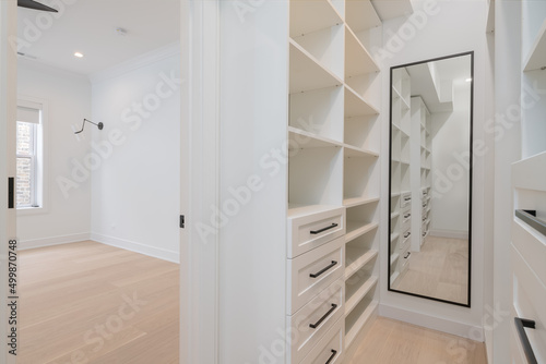 Custom Closet Organization. Contemporary closet design with shelves, drawers and rods. photo