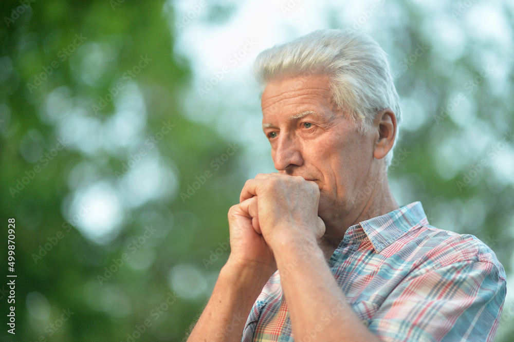 Portrait of thinking senior man in park Portrait of thinking senior man in park