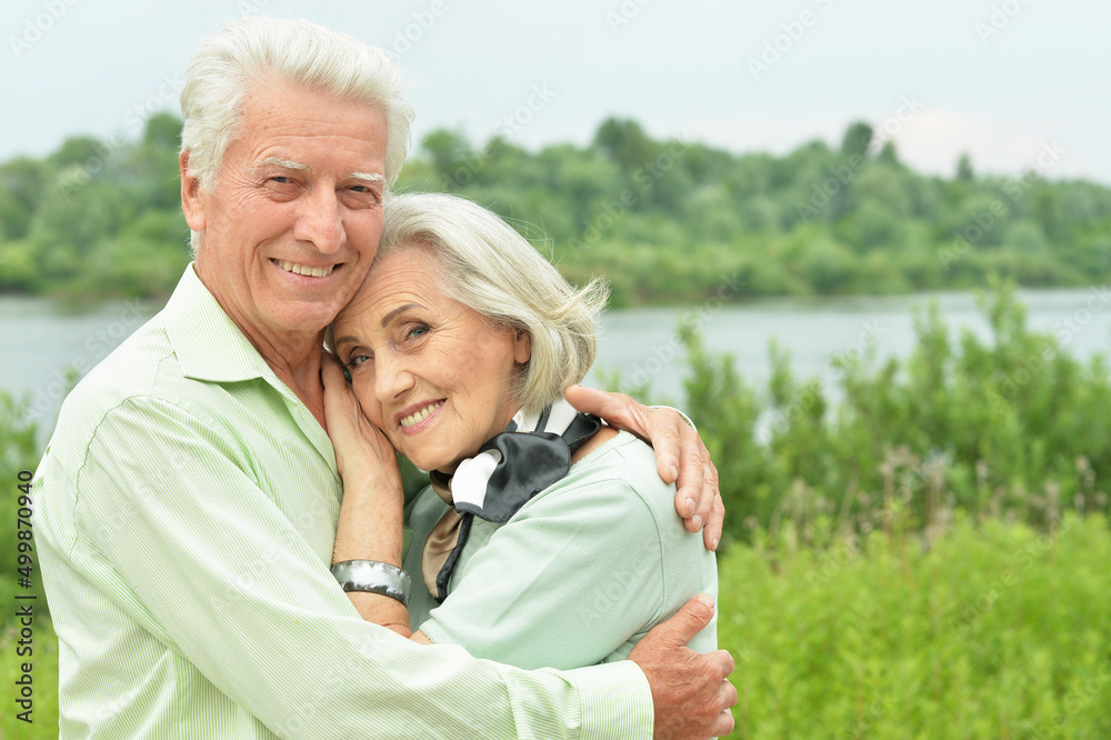 Beautiful senior couple hugging in the park Beautiful senior couple hugging in the park