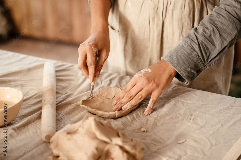 Young black ceramist woman sculpting in clay at her workshop Young black ceramist woman sculpting in clay at her workshop