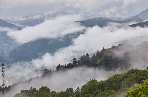 Majestic view on beautiful fog mountains in mist landscape. Dramatic unusual scene. Travel background. Exploring beauty world.