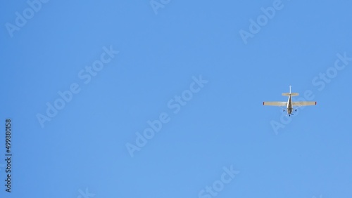 Small recreational plane, ideal for flight practice flying over a blue sky on a clear day