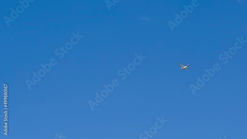 Small recreational plane, ideal for flight practice flying over a blue sky on a clear day