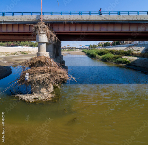 Piura, Peru: Debris accumulated at the base of a bridge caused by a flash flood photo