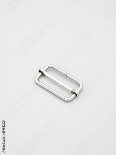 Metal adjusters and frames for making bags and backpacks on a dark grey background. Chrome-plated metal frames for handbags straps. Sewing accessories  bags making