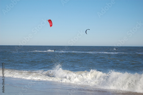 A kiteboarder surfing the waves, off the coast of the Atlantic Ocean, Assateague Island, Worcester County, Maryland.