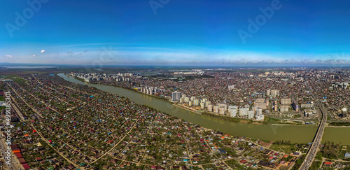 Large aerial panorama of the Kuban River near the Turgenev bridge in the city of Krasnodar on a sunny April day