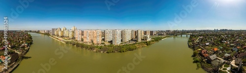panoramic aerial view of new buildings near the Turgenev bridge on the southwestern part of the Krasnodar city center and the Kuban river on a spring sunny day.