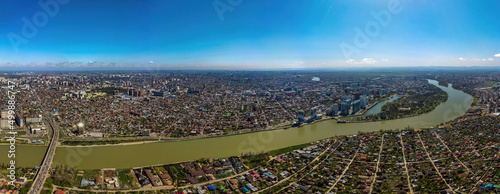 Panoramic aerial view of the southwestern part of Krasnodar city center and the Kuban river on a spring sunny day.