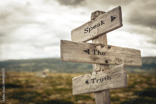 speak the truth text quote written in wooden signpost outdoors in nature. Moody theme feeling. photo