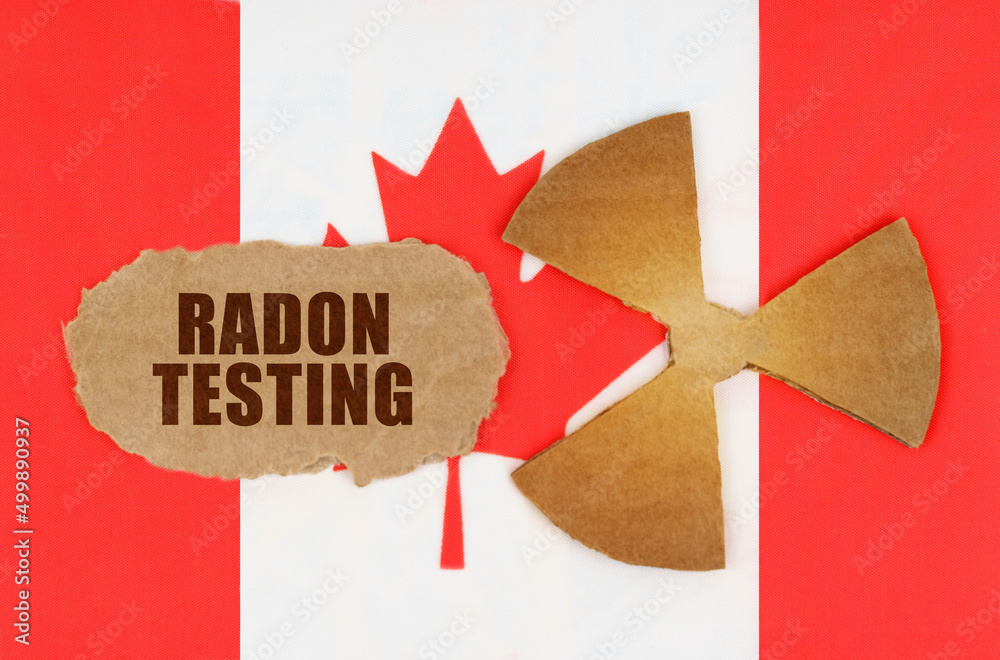 On The Flag Of Canada The Symbol Of Radioactivity And Torn Cardboard on-the-flag-of-canada-the-symbol-of-radioactivity-and-torn-cardboard