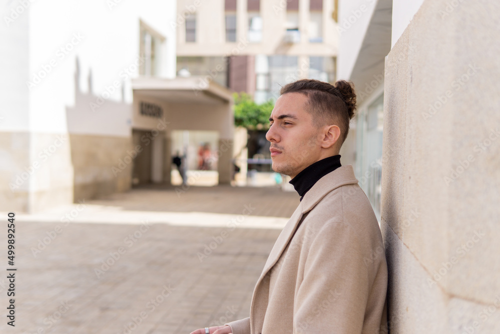 Portrait of a young mixed-race man with a pensive look in the city Portrait of a young mixed-race man with a pensive look in the city