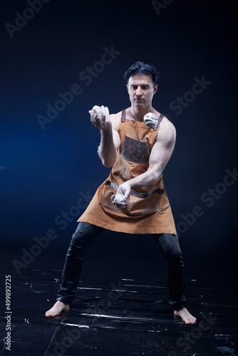  A man profession juggler, is juggling a balls isolated on black background