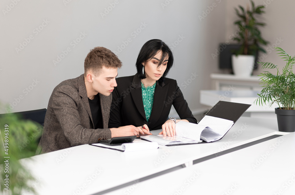 Businessman and businesswoman meeting in modern office working on laptop, business meeting Businessman and businesswoman meeting in modern office working on laptop, business meeting