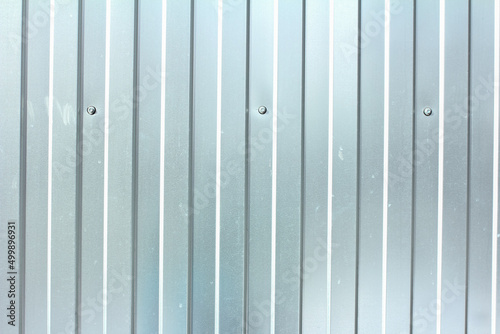 Gray corrugated steel fence, metal profiled sheet texture 