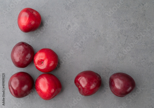 A group of plums over stone background with copy space
