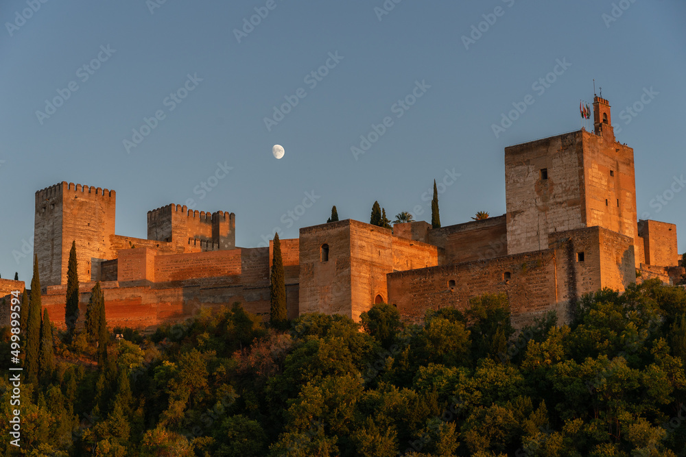 Panoramic view of the Alhambra and the moon at sunset