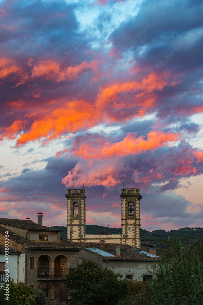 Fire clouds during sunset on a skyline with church towers
