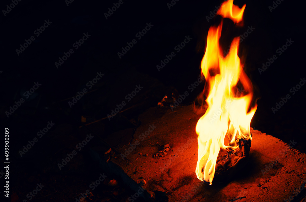 Bright fire torch on a dark background. White yellow red flame. Bright fire torch on a dark background. White yellow red flame.