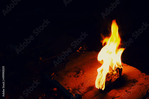 Bright fire torch on a dark background. White yellow red flame.