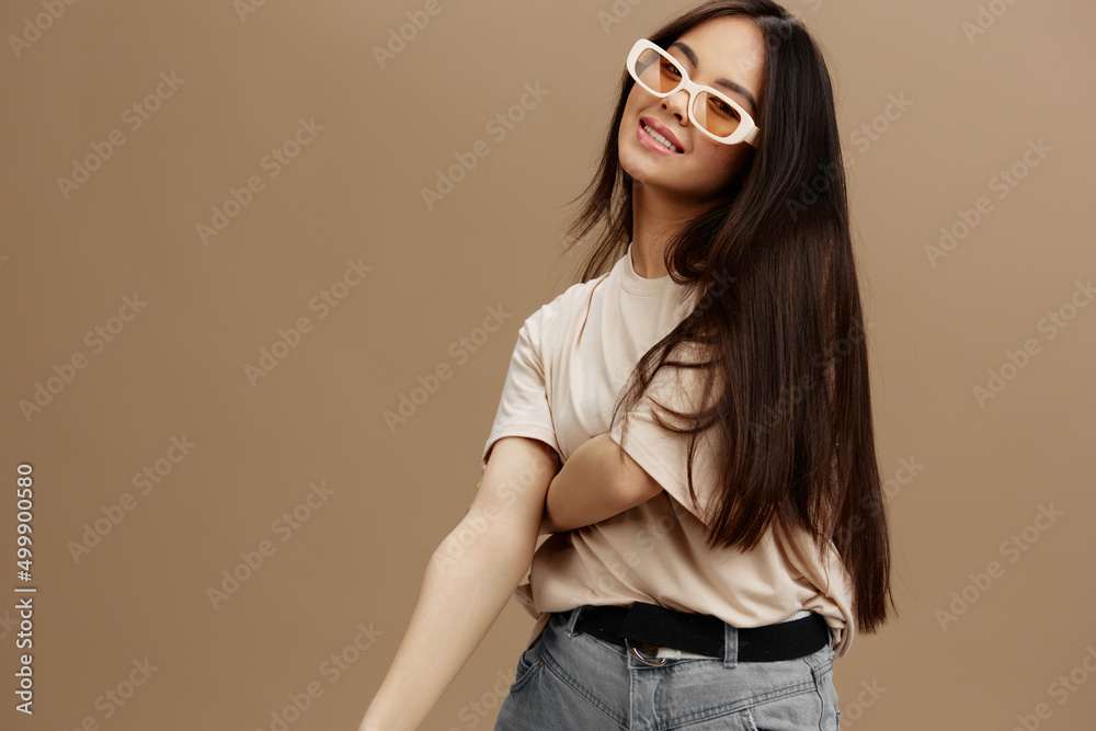 woman in a beige T-shirt with glasses posing clothing fashion studio model woman in a beige T-shirt with glasses posing clothing fashion studio model