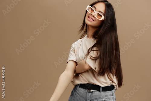 woman in a beige T-shirt with glasses posing clothing fashion studio model