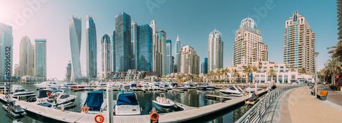 Photography Yachts are moored at city pier, jetty in Dubai Marina