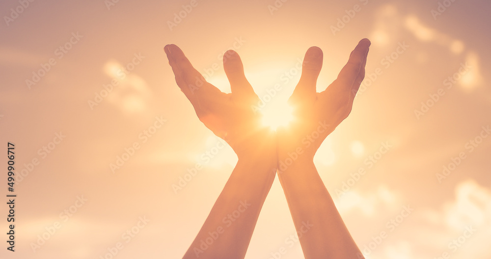 Hands reaching out to sky, warm sunshine in the palm of hands. Spiritual prayer, recovery, healing concept. Hands reaching out to sky, warm sunshine in the palm of hands. Spiritual prayer, recovery, healing concept.