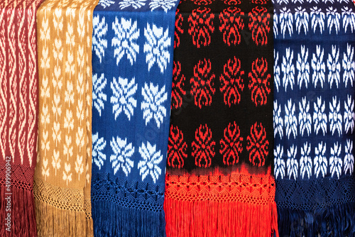 Scarves or Macanas at the market, traditional handcraft and design for Gualaceo canton, Azuay province, made by using technique called Ikat. Colorful fabrics background. Cuenca, Ecuador photo