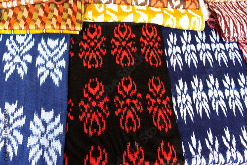 Ecuadorian scarves or Macanas. Traditional colorful craft and design for Gualaceo canton, Azuay province on the display at street market. Scarves made by technique called IKAT from cotton or wool. photo
