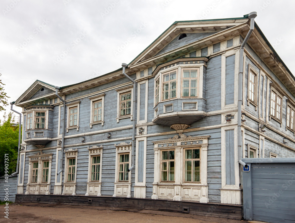Fototapeta premium Facade of wooden house of Decembrist Sergei Volkonsky in Irkutsk in summer in cloudy weather.