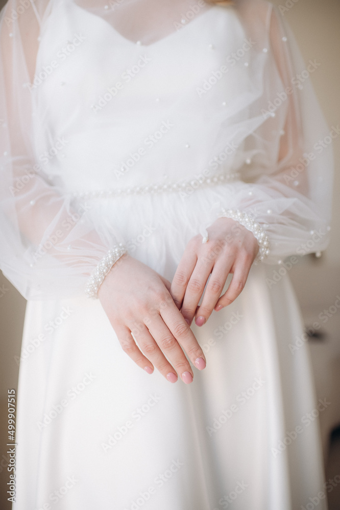 bride in a wedding dress gently touches the ring with her fingers bride in a wedding dress gently touches the ring with her fingers
