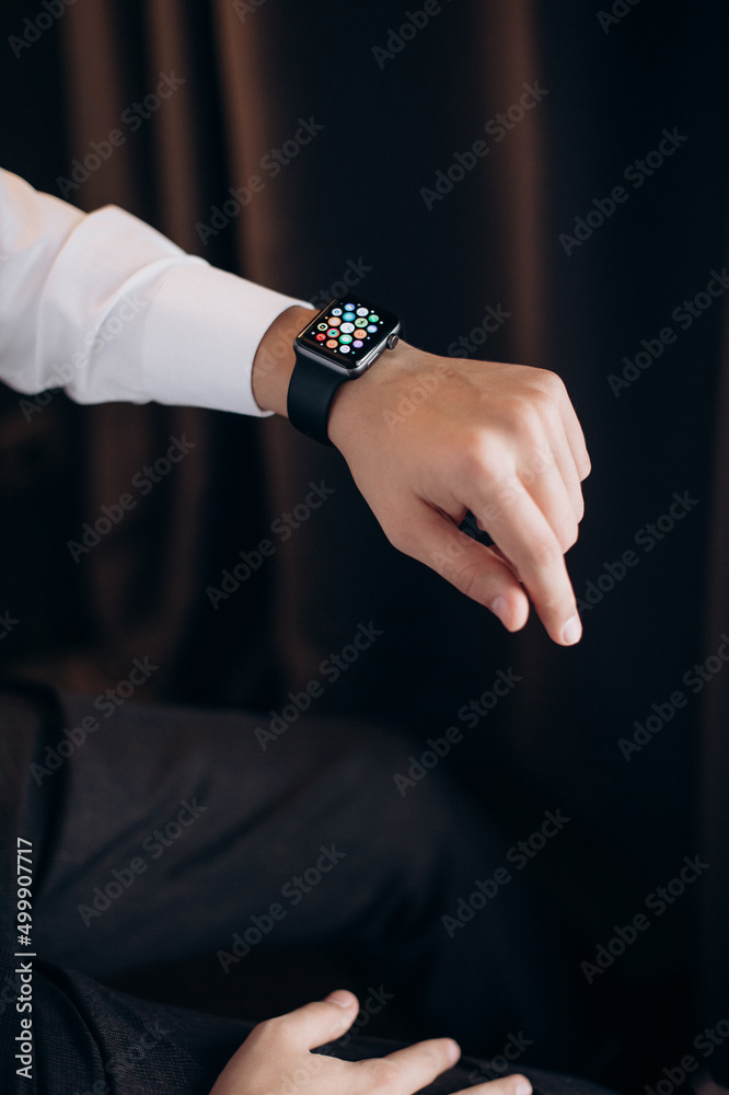 businessman in suit looking at wrist watch