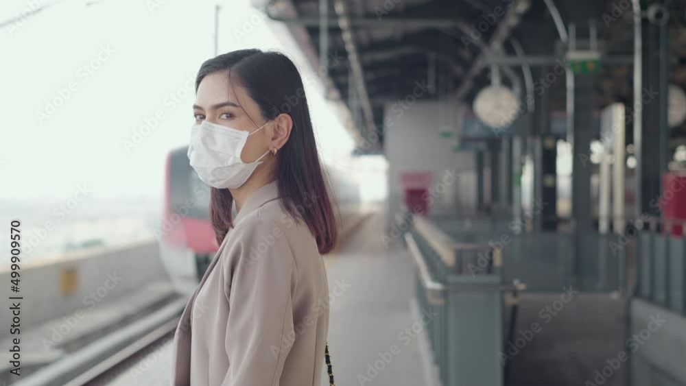 A young woman is wearing protective mask in metro. Platform , covid-19 protection , safety transportation , travel under pandemic concept . A young woman is wearing protective mask in metro. Platform , covid-19 protection , safety transportation , travel under pandemic concept .