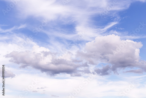 Beautiful epic soft gentle cloudy blue sky with many white cirrus and fluffy clouds  abstract background texture  heaven
