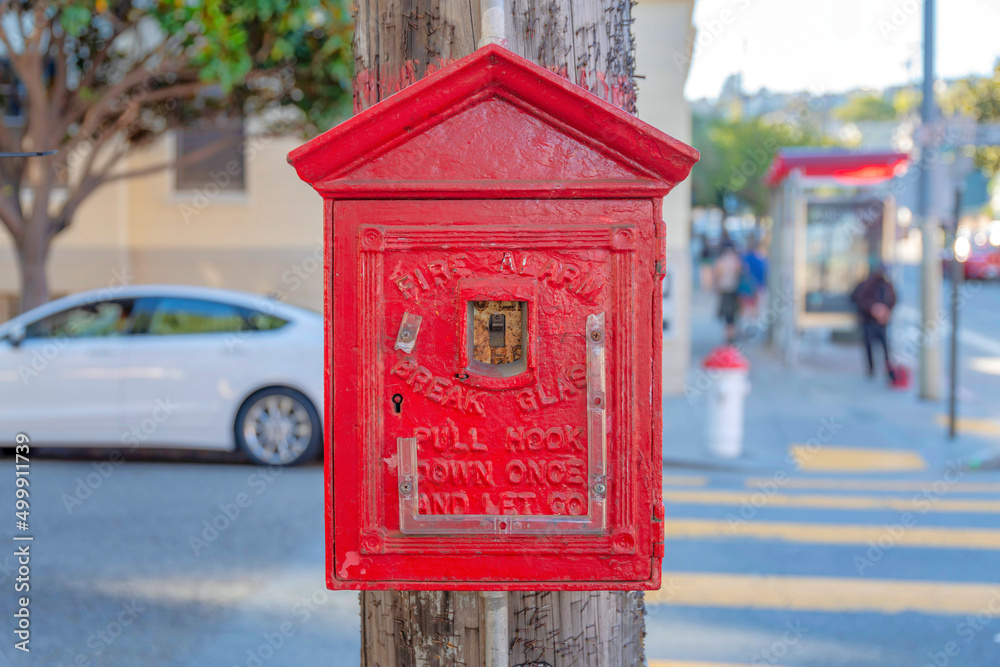 Fire alarm inside the small red house on a wooden post at crosswalk in San Francisco, California Fire alarm inside the small red house on a wooden post at crosswalk in San Francisco, California