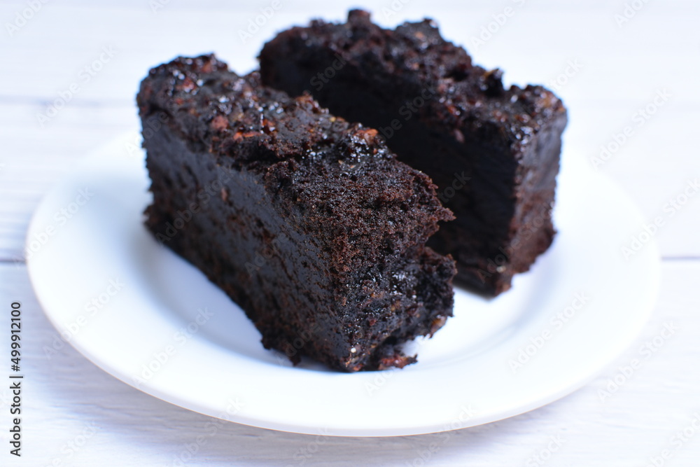Traditional black ponque, with raisins, red wine flavor on wooden background Traditional black ponque, with raisins, red wine flavor on wooden background