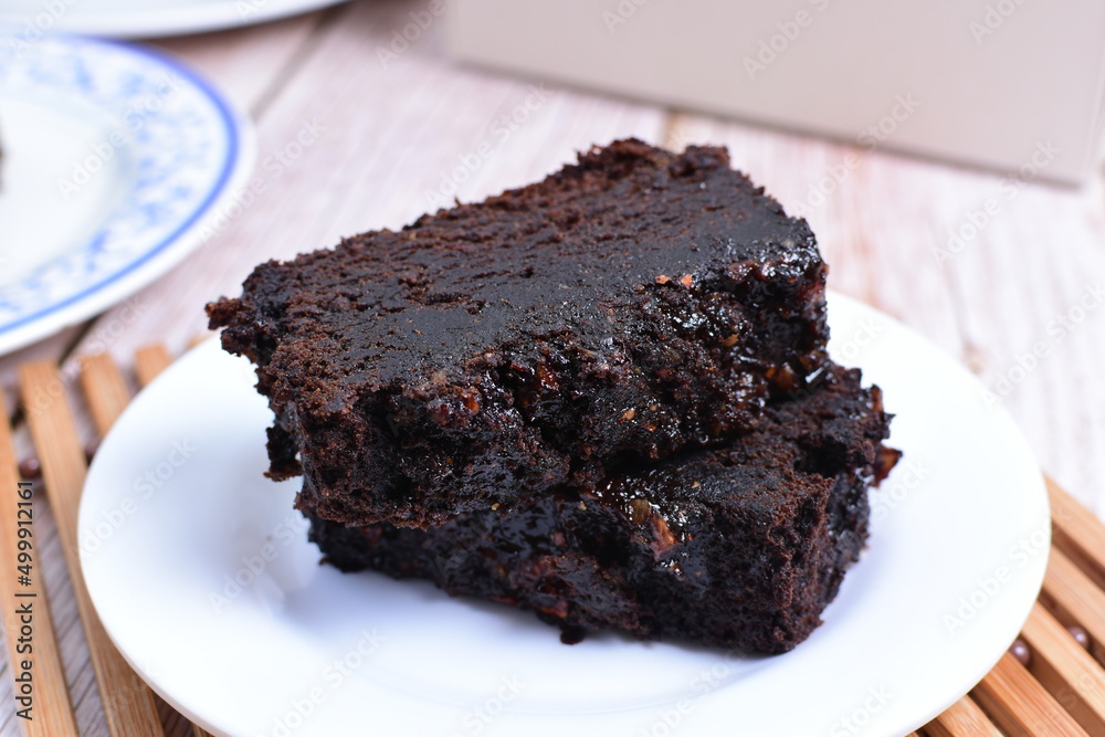 Traditional black ponque, with raisins, red wine flavor on wooden background Traditional black ponque, with raisins, red wine flavor on wooden background