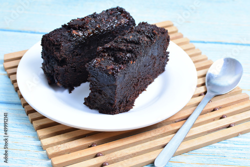 Traditional black ponque, with raisins, red wine flavor on wooden background