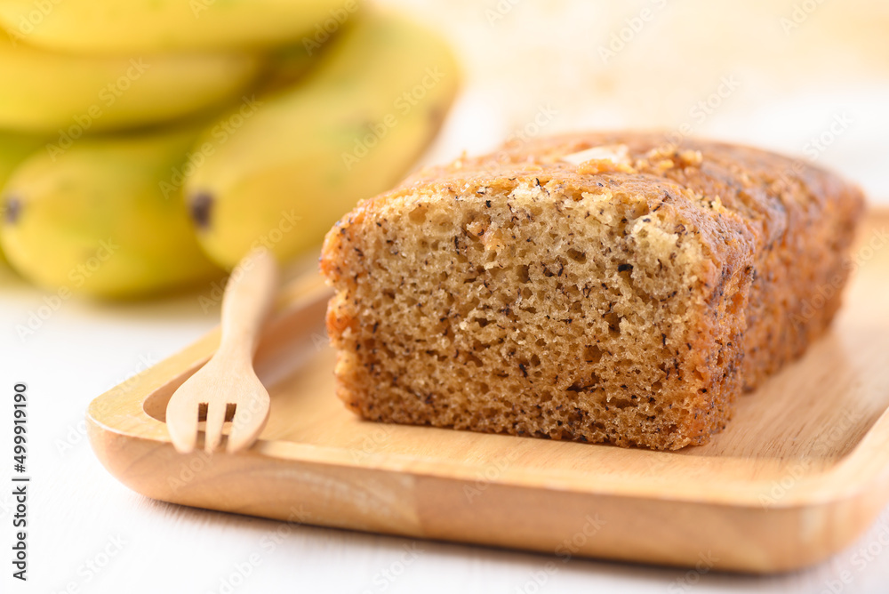 Banana bread on wooden plate with fork ready to eating Banana bread on wooden plate with fork ready to eating