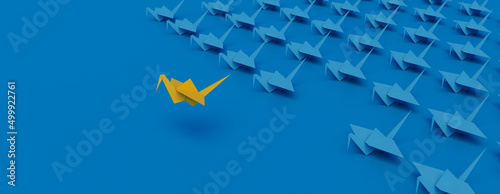 Yellow Origami Bird Leading the Group. Modern Victory Concept on Blue Background with Copy Space.