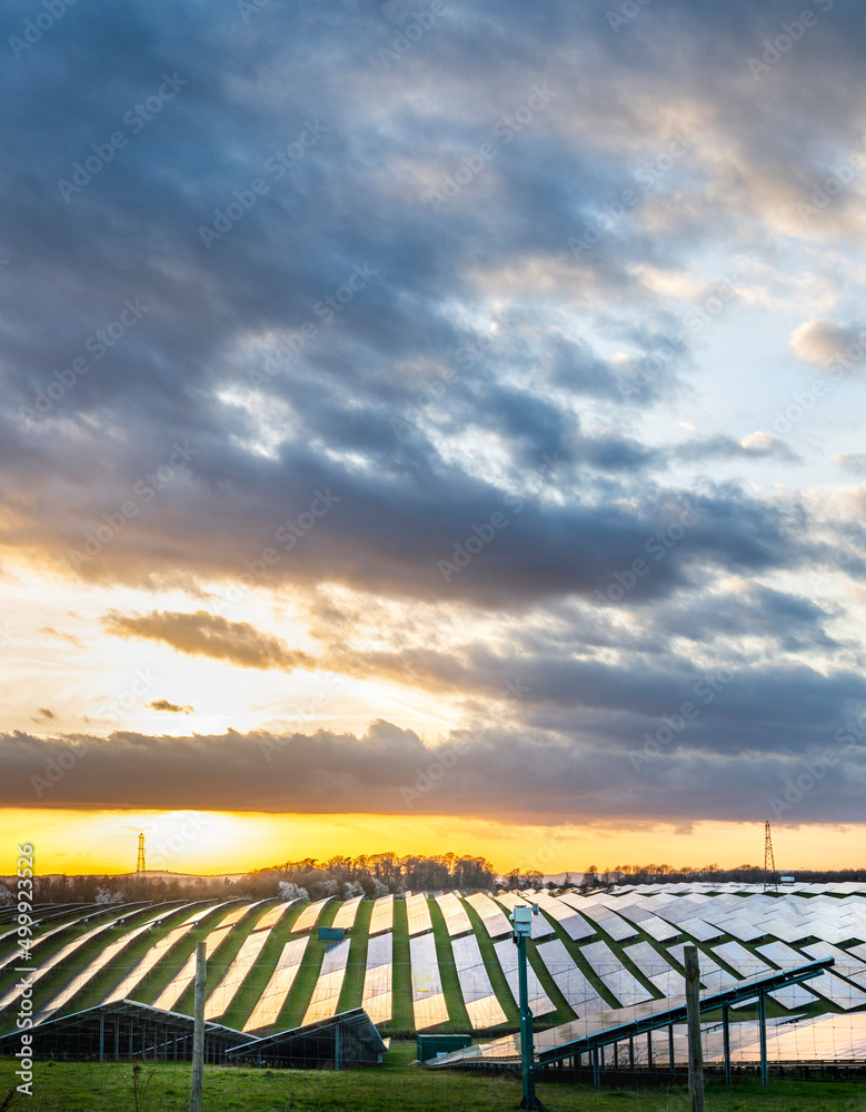 UK Solar Park at sunset,vibrant golden sunlight reflecting from panels,Hampshire,England,United Kingdom. UK Solar Park at sunset,vibrant golden sunlight reflecting from panels,Hampshire,England,United Kingdom.