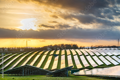 UK Solar Park at sunset,vibrant golden sunlight reflecting from panels,Hampshire,England,United Kingdom.
