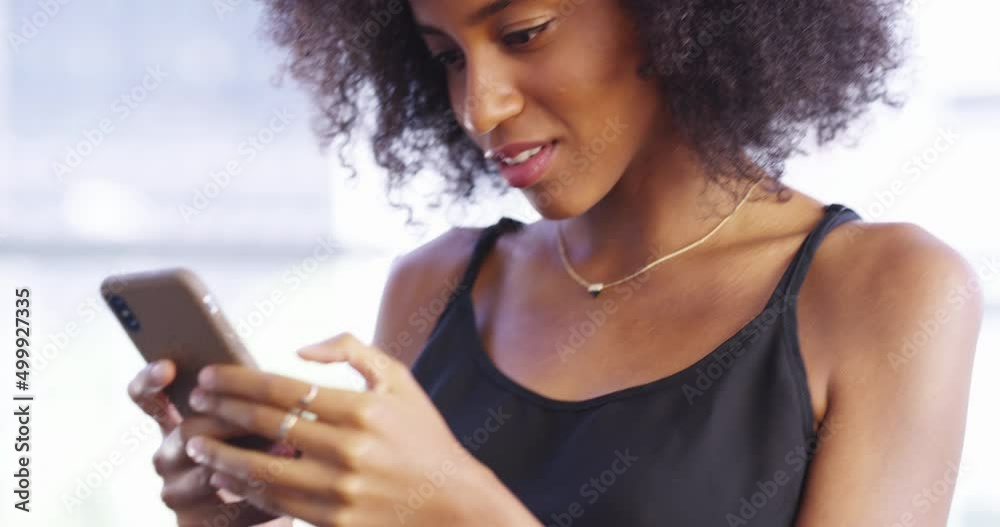Joining in with a connected world. 4k video footage of an attractive young woman texting on her cellphone at home. Joining in with a connected world. 4k video footage of an attractive young woman texting on her cellphone at home.