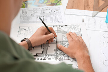 Young male landscape designer working in office