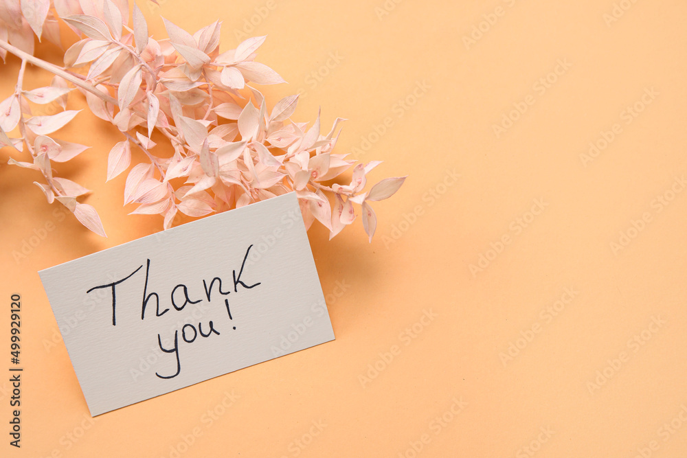 Sheet of paper with text THANK YOU and plant branch on color background