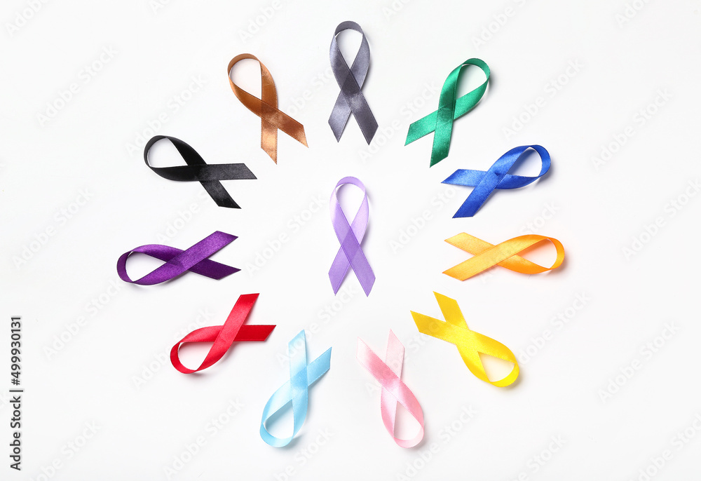 Fototapeta premium Different colorful awareness ribbons on white background. World Cancer Day