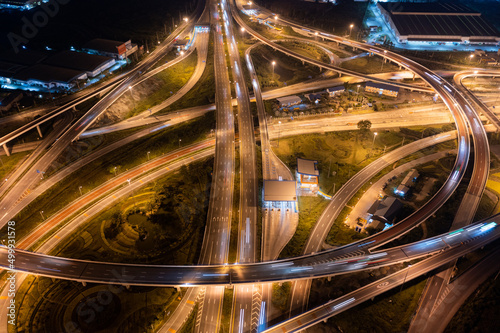 Aerial view of highway junctions with roundabout. Bridge roads shape circle in structure of architecture and transportation concept. Top view. Urban city, Bangkok at sunset, Thailand © Sathit Trakunpunlert